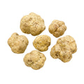 Big fresh Tuber magnatum white truffles with pale ochre surfaces and natural shape variation