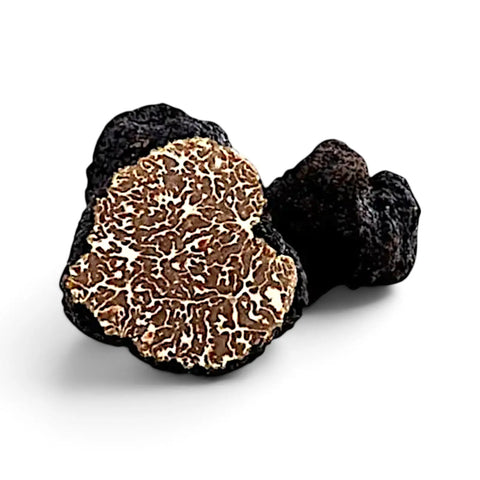 Whole and cut Tuber mesentericum Bagnoli truffles showing the dark exterior and marbled interior