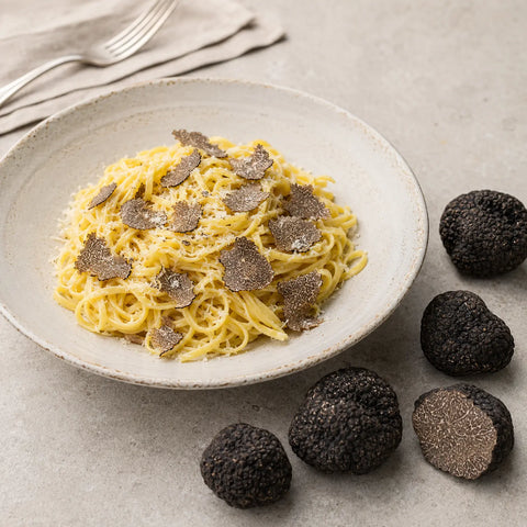 Fresh Tuber indicum Chinese Black Truffles shaved over a refined savoury dish
