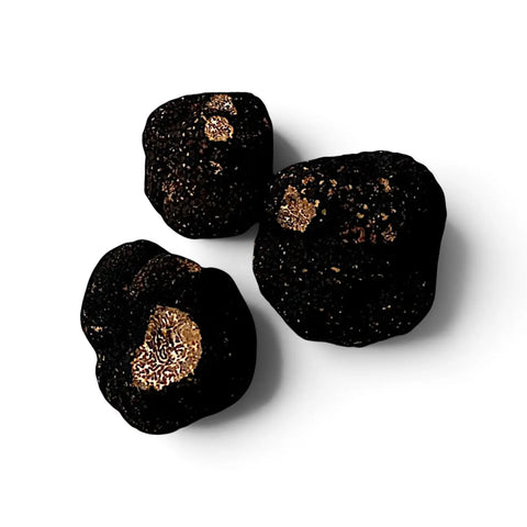 Whole and cut Tuber mesentericum Bagnoli truffles showing dark outer skin and marbled interior