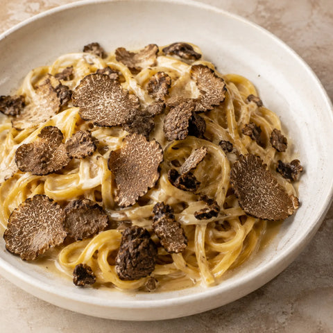 Frozen Black Summer Truffle – Tuber aestivum sliced over creamy tagliolini pasta